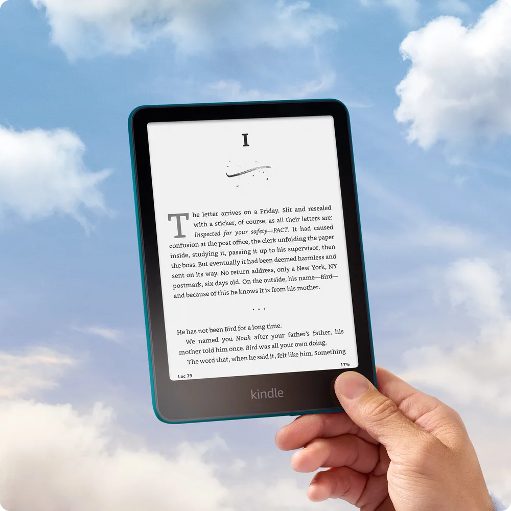 Amazon Kindle Paperwhite held against a blue sky